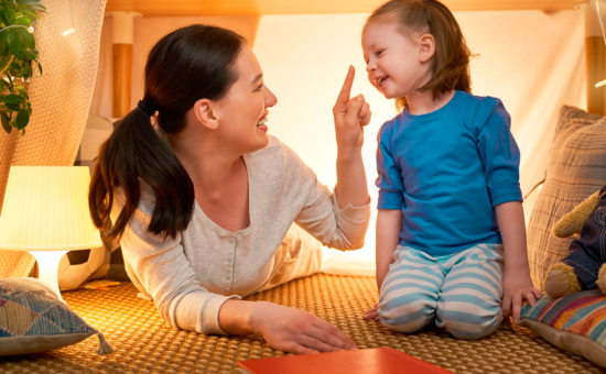 Mother with Special Needs Child Playing in Child's Room